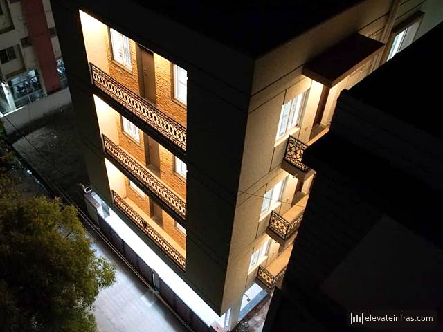 Manchester Enclave at night with the balconies lit